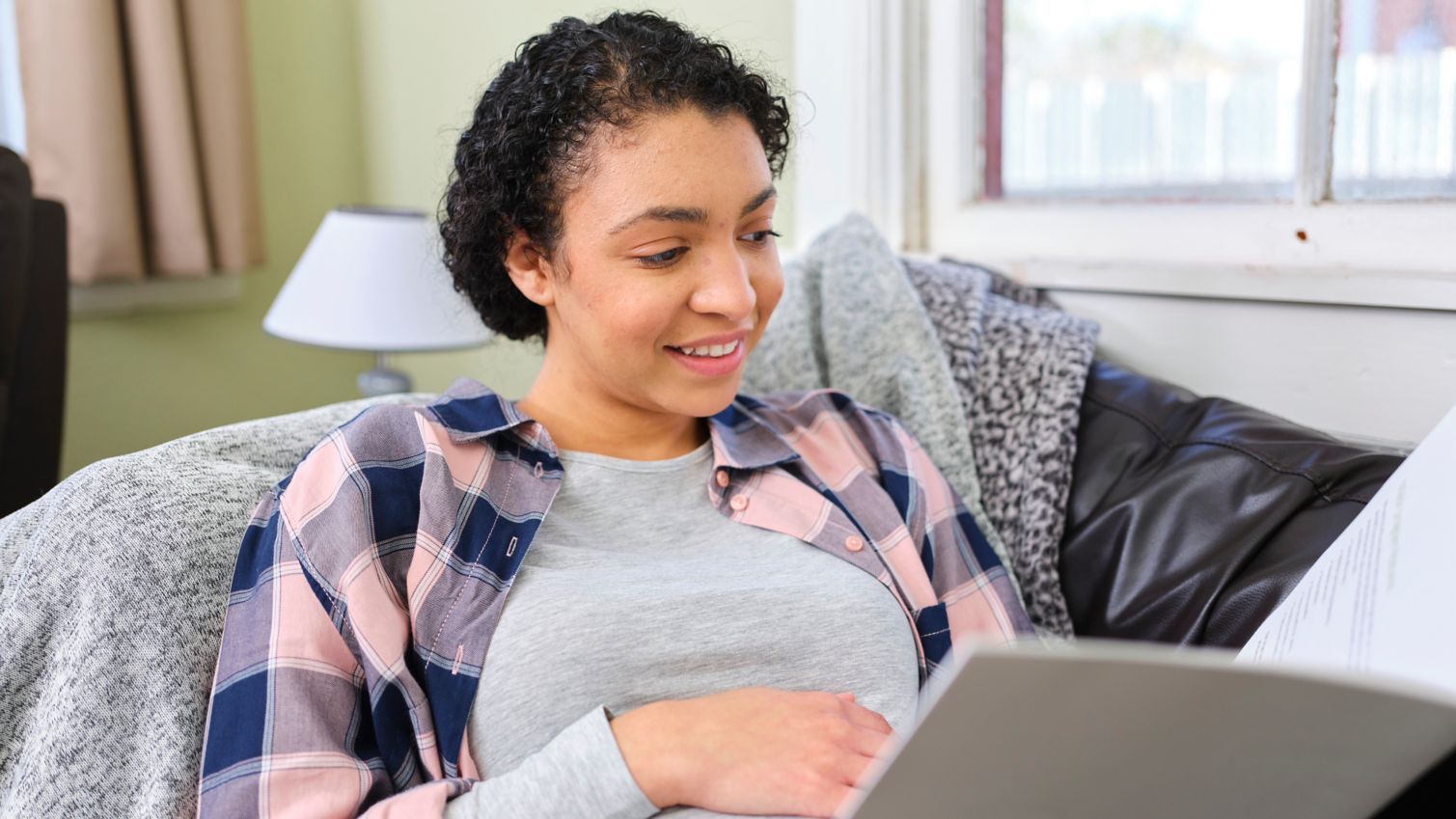 Pregnant woman reads paperwork