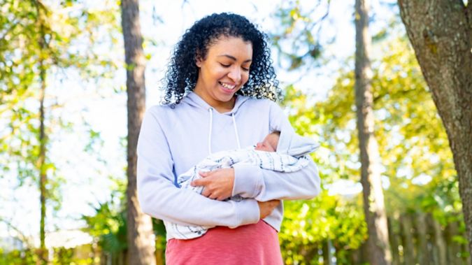 A smiling mouther holding her baby