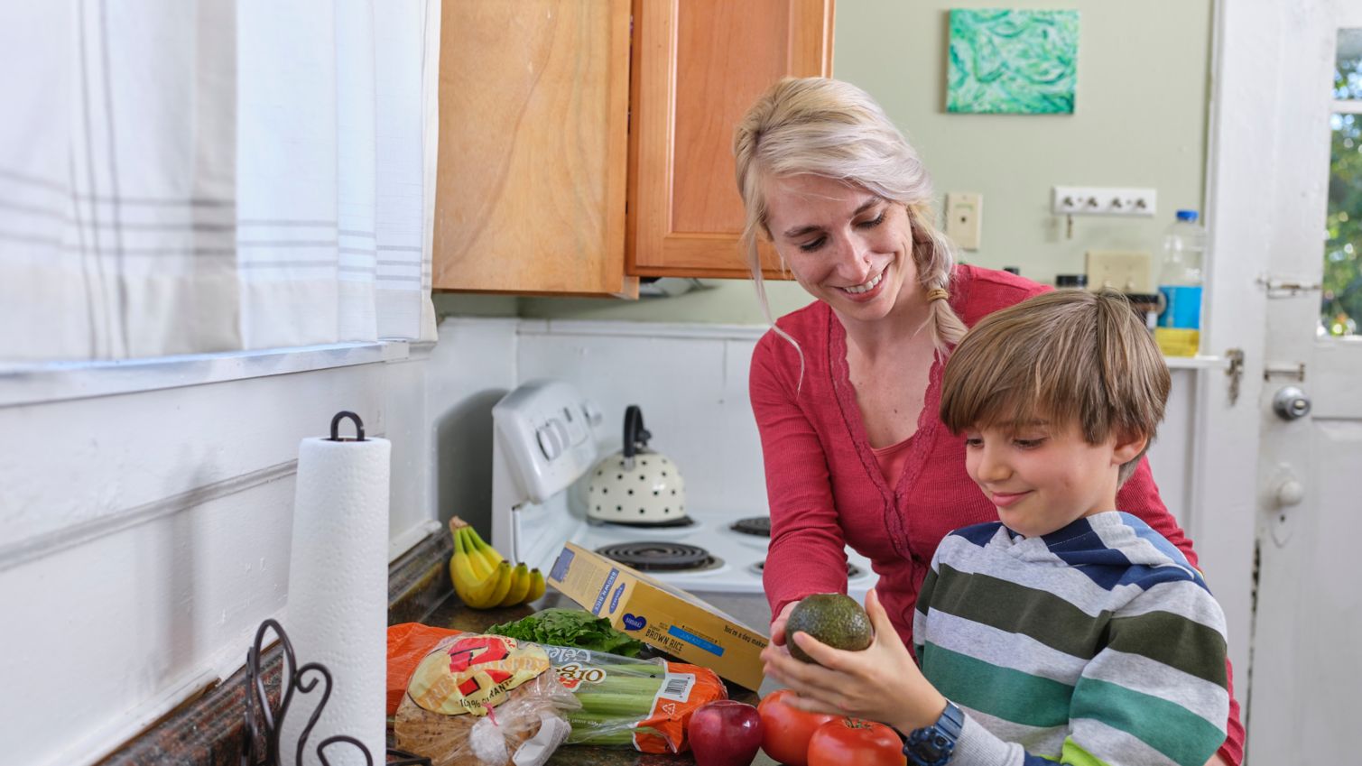 Mom and young son pick out healthy food