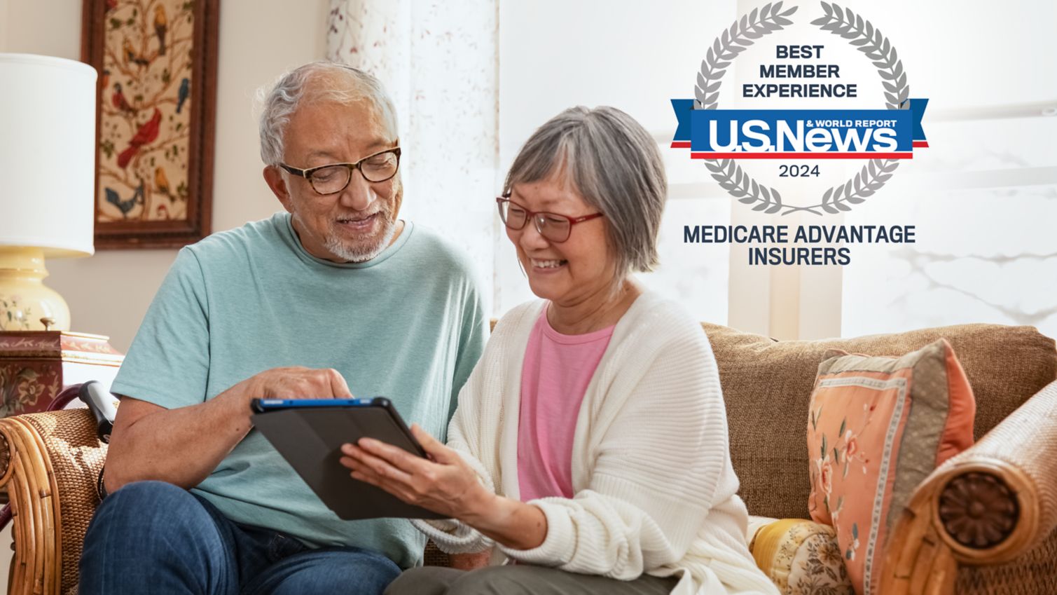 A couple uses a tablet in their living room. 