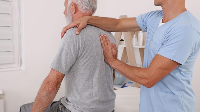 A man receives chiropractic care. 