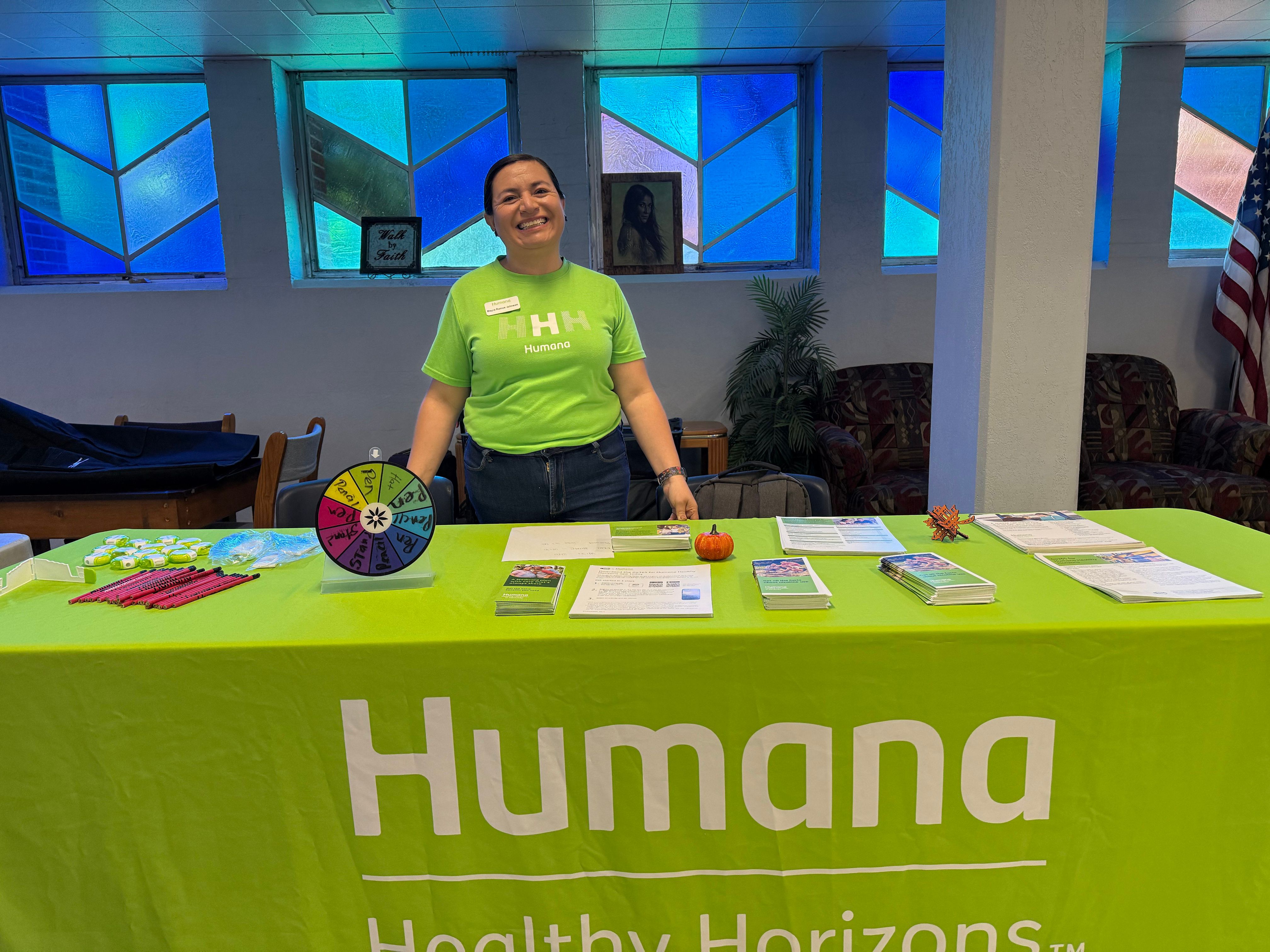 Mayra Johnson, a Community Engagement Professional with Humana Healthy Horizons in Kentucky, volunteers at See Forward Ministries in Louisville to give neighbors vouchers for culturally appropriate food items.