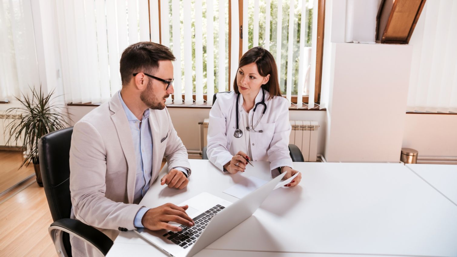 Two healthcare professionals chatting at a table
