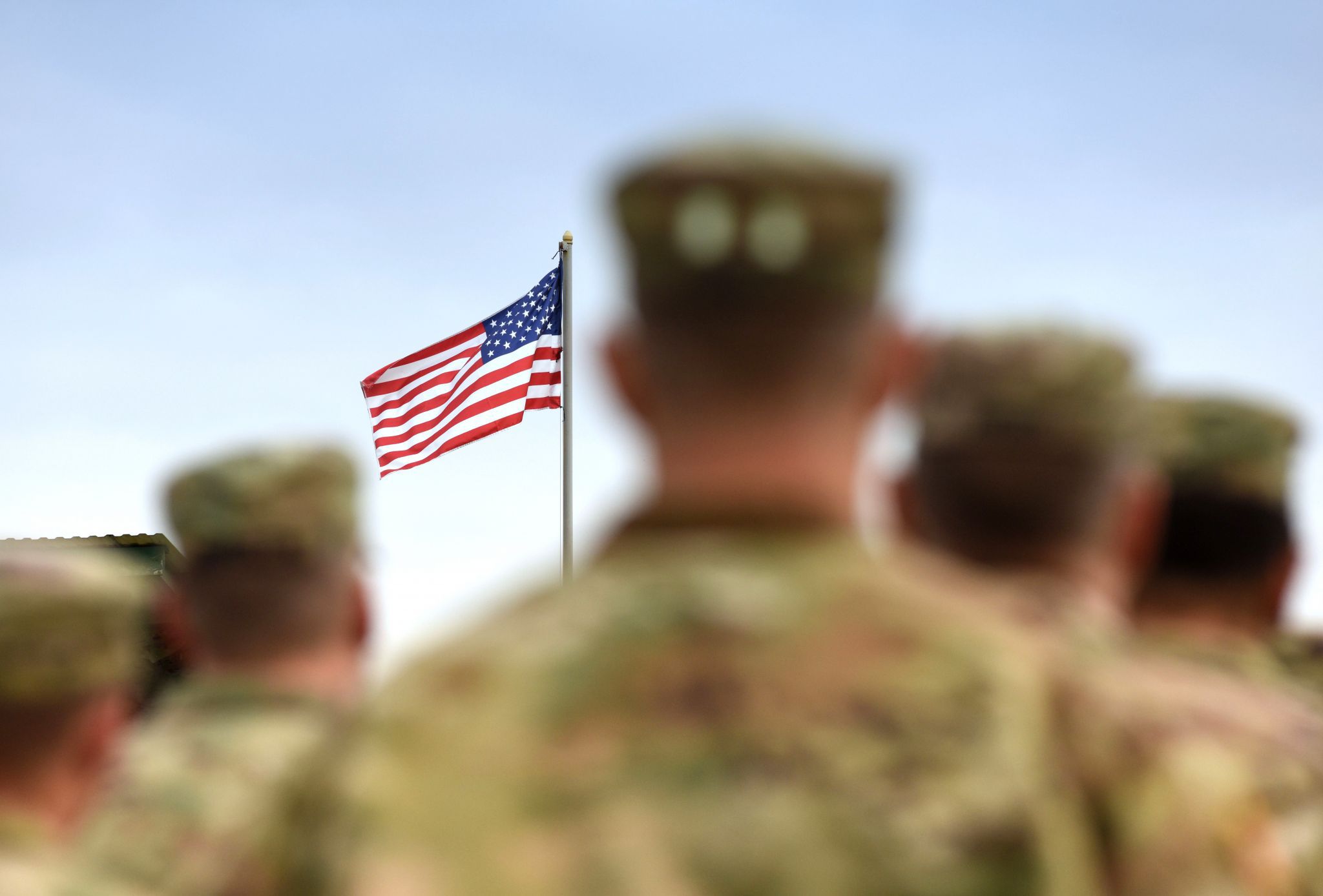 Army veterans saluting flag