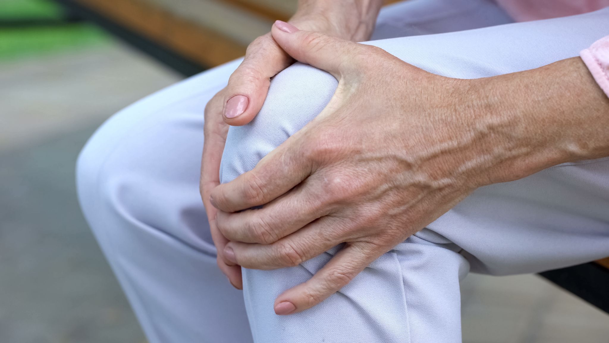 Person holding knee joint pain