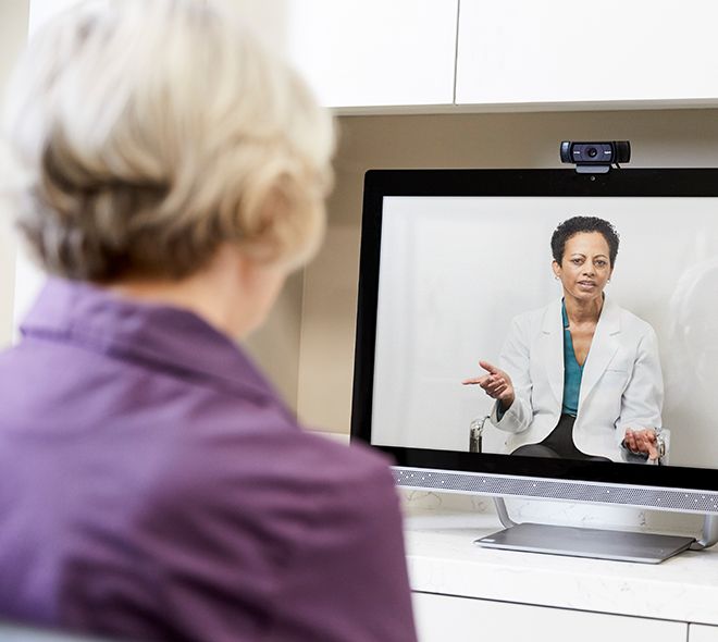 Senior receiving virtual care from her doctor via televisit on her computer
