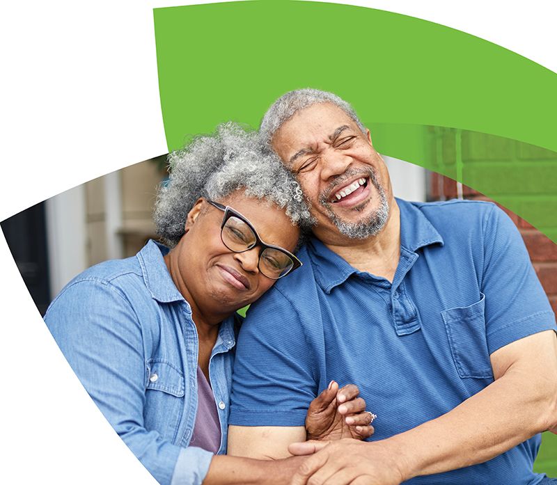 Woman smiling while sitting cross-legged in front of CenterWell logo