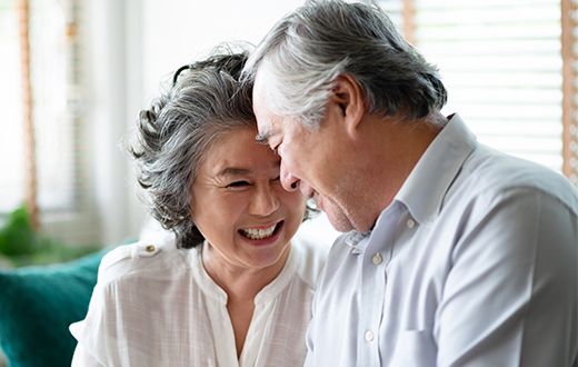 Senior Asian couple smiling and laughing